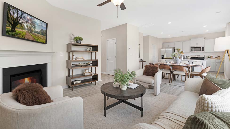 Open family room with electric fireplace and windows