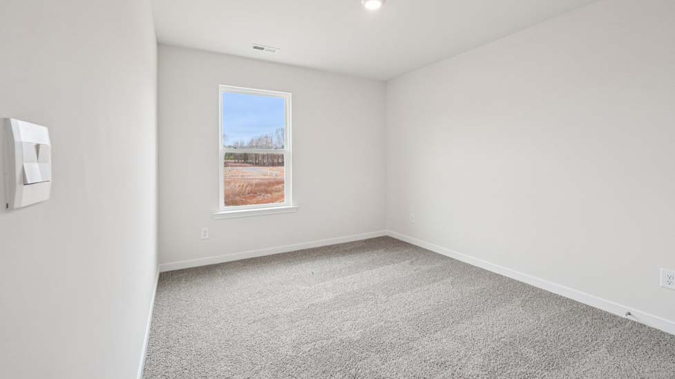 Carpeted bedroom with large window