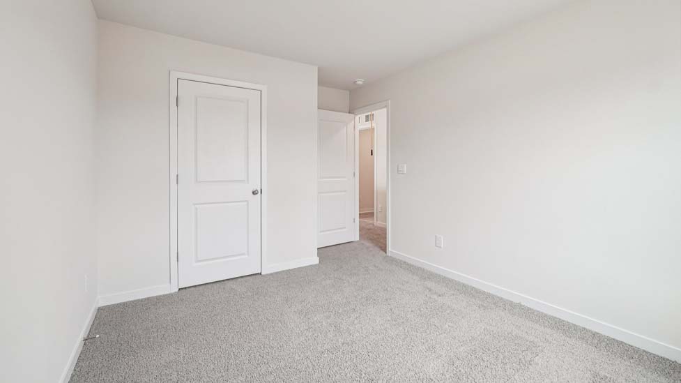 Carpeted bedroom with large window