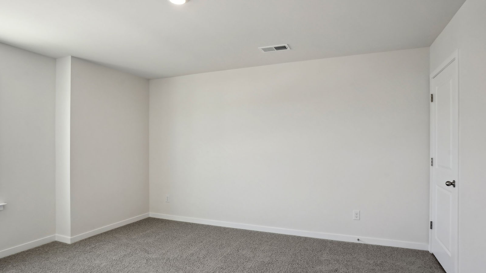 carpeted bedroom with large window