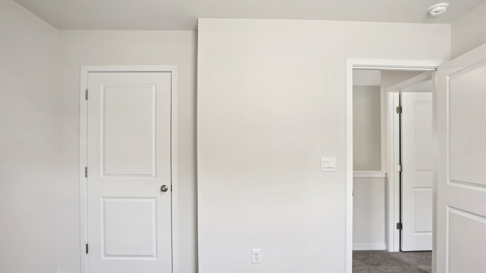 carpeted bedroom with large window