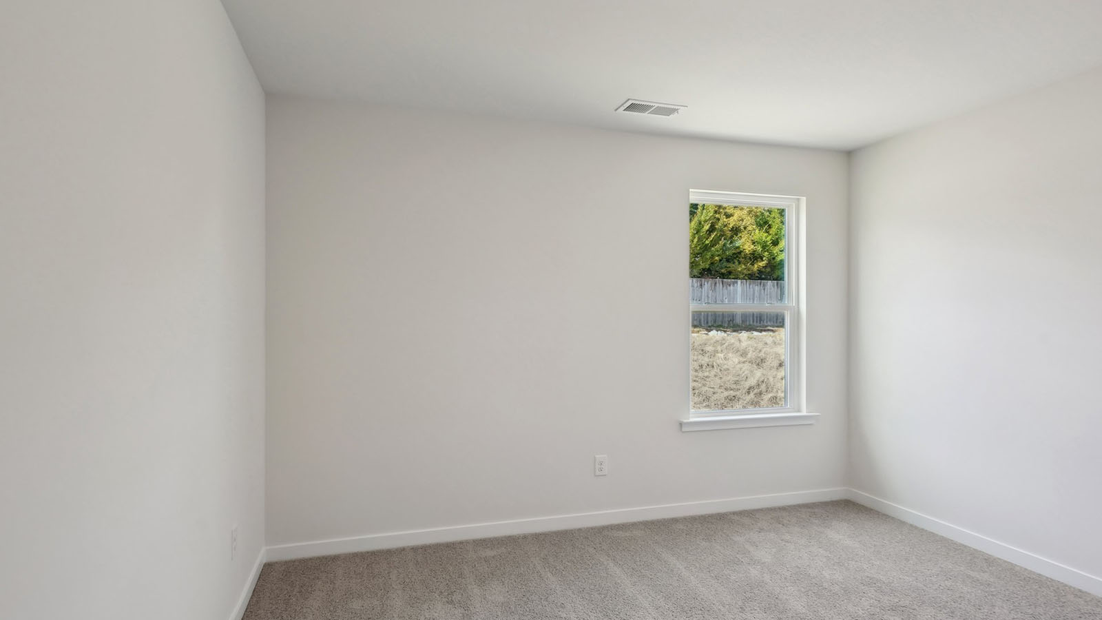 carpeted bedroom with large window