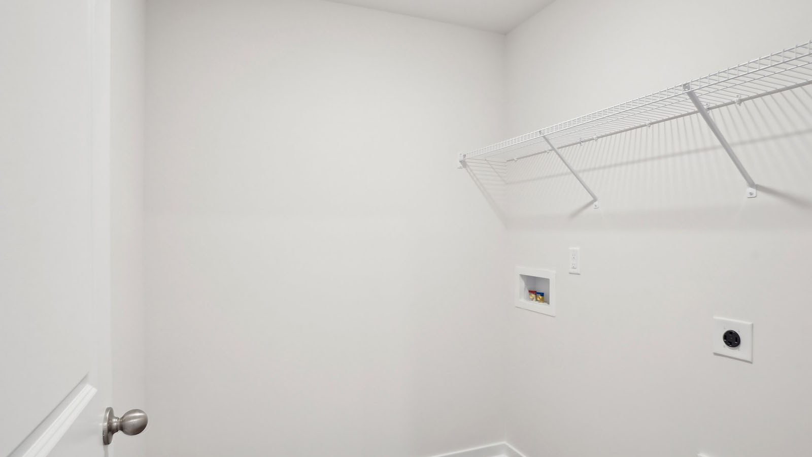 Laundry room with built in hanger and storage racks above machines