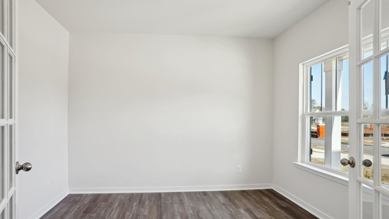 Dining room with wood floors, and sliding glass back door