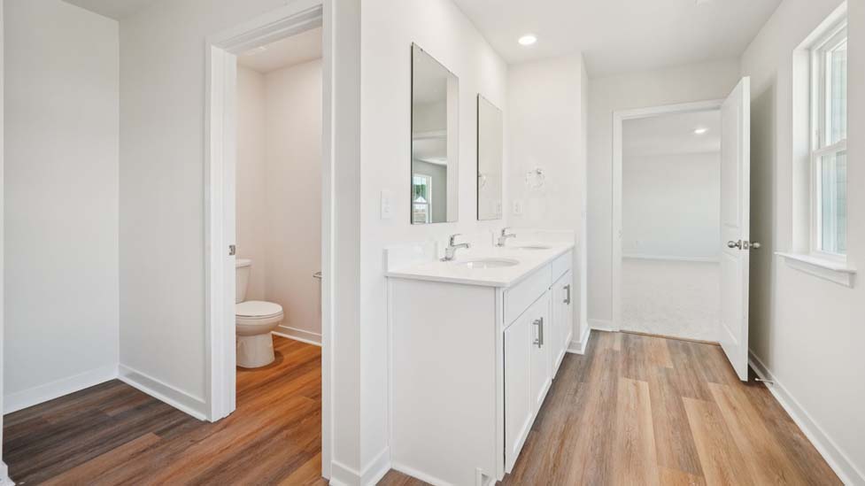Primary bathroom with double sink vanity and walk in shower