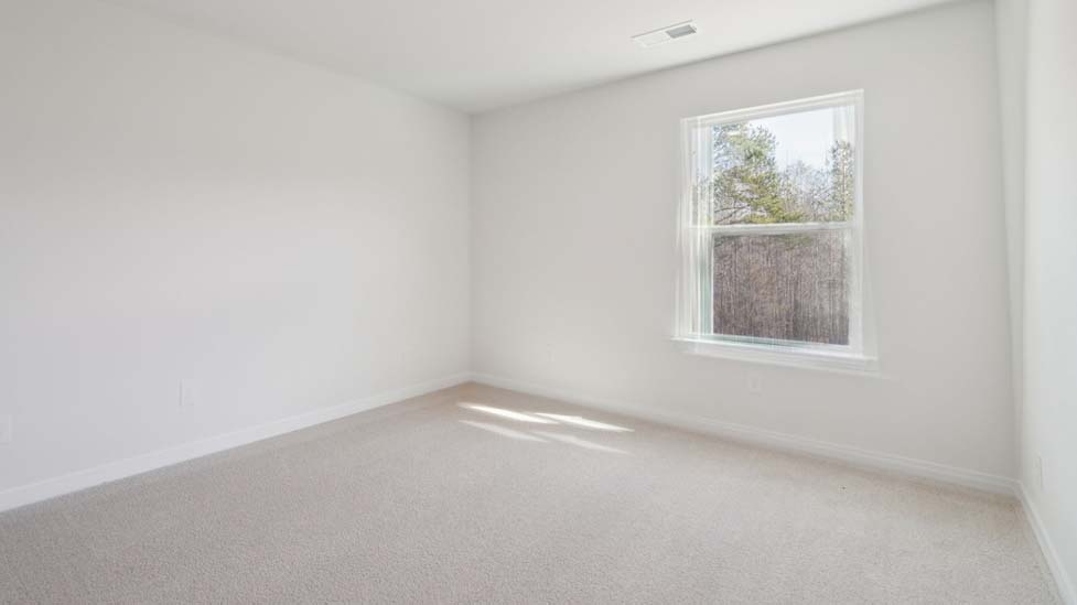 Carpeted bedroom with large window