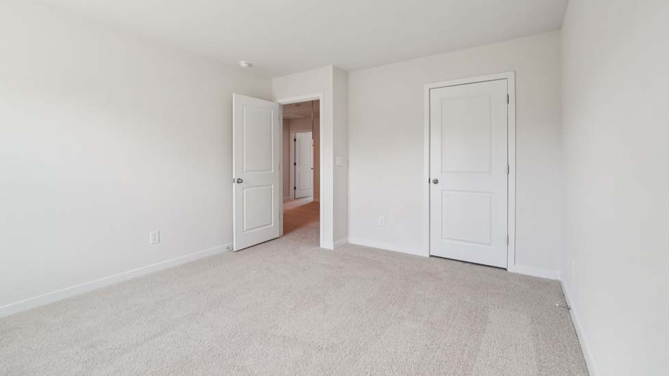 Carpeted bedroom with large window