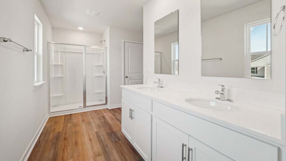 Primary bathroom with double sink vanity and walk in shower