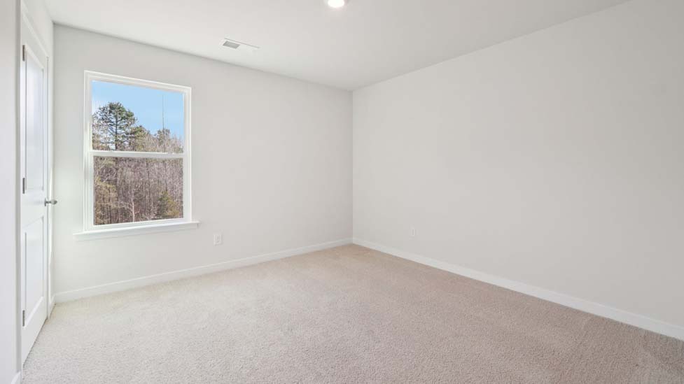 Carpeted bedroom with large window