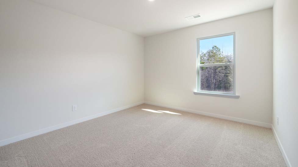 Carpeted bedroom with large window