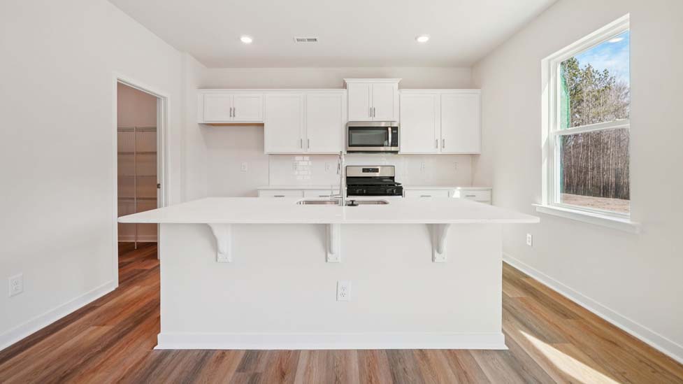 Kitchen and island with stainless steel appliances