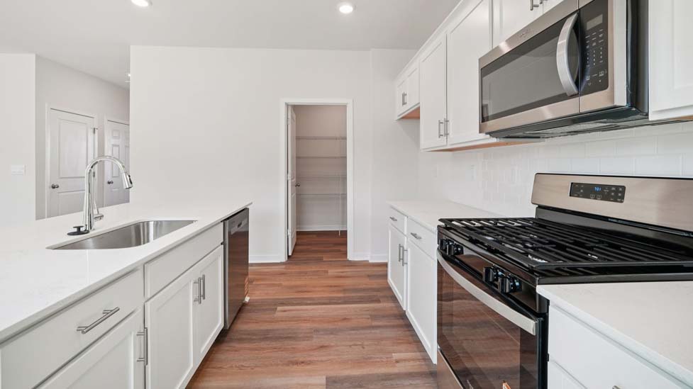 Kitchen and island with stainless steel appliances