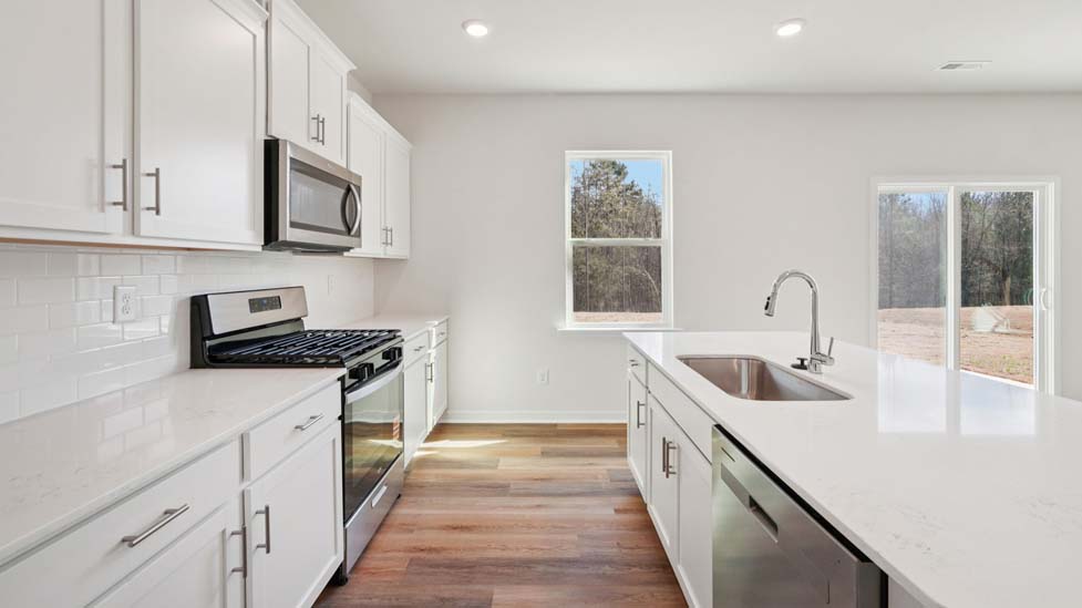 Kitchen and island with stainless steel appliances