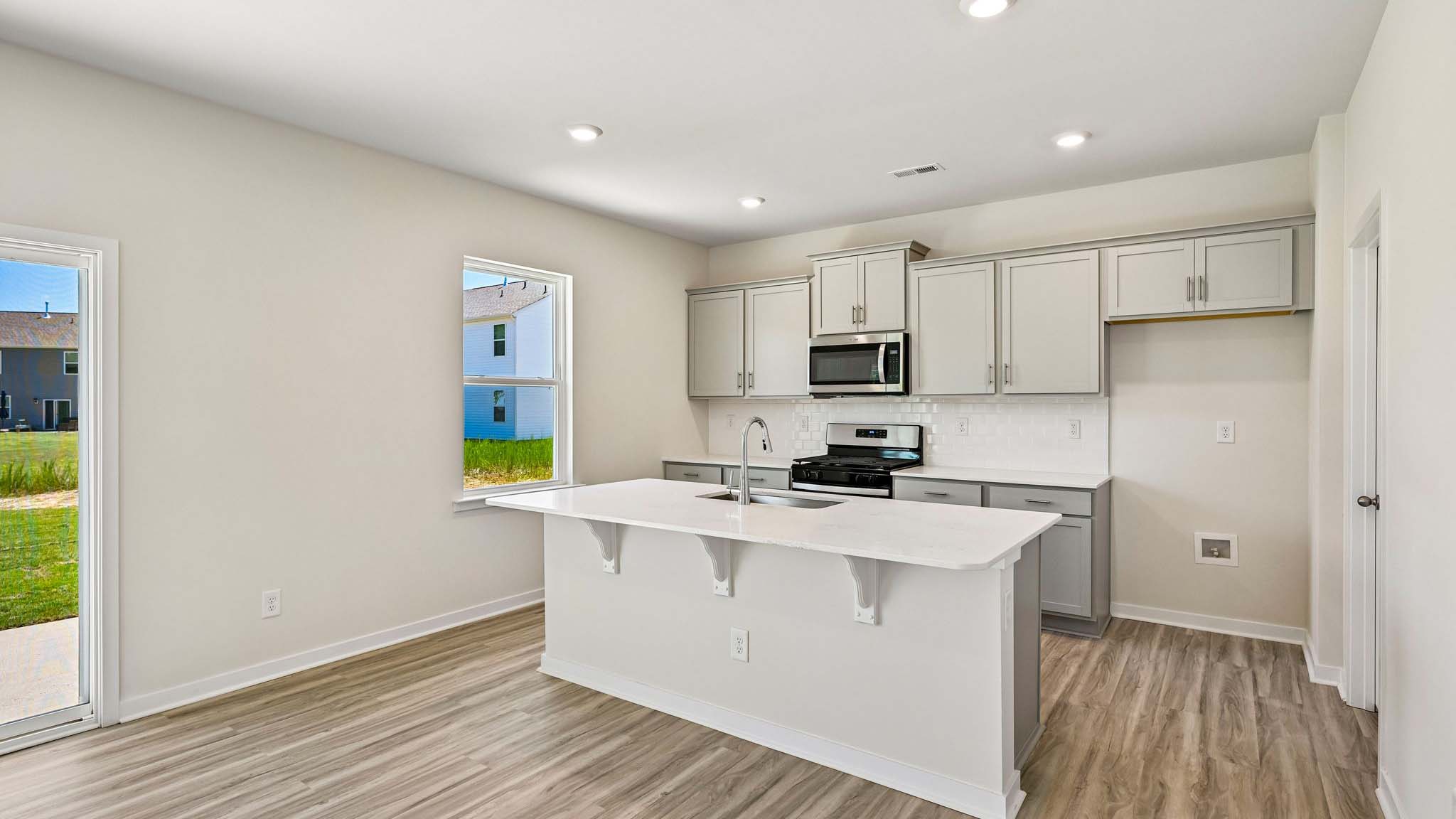 kitchen and island with stainless steel appliances