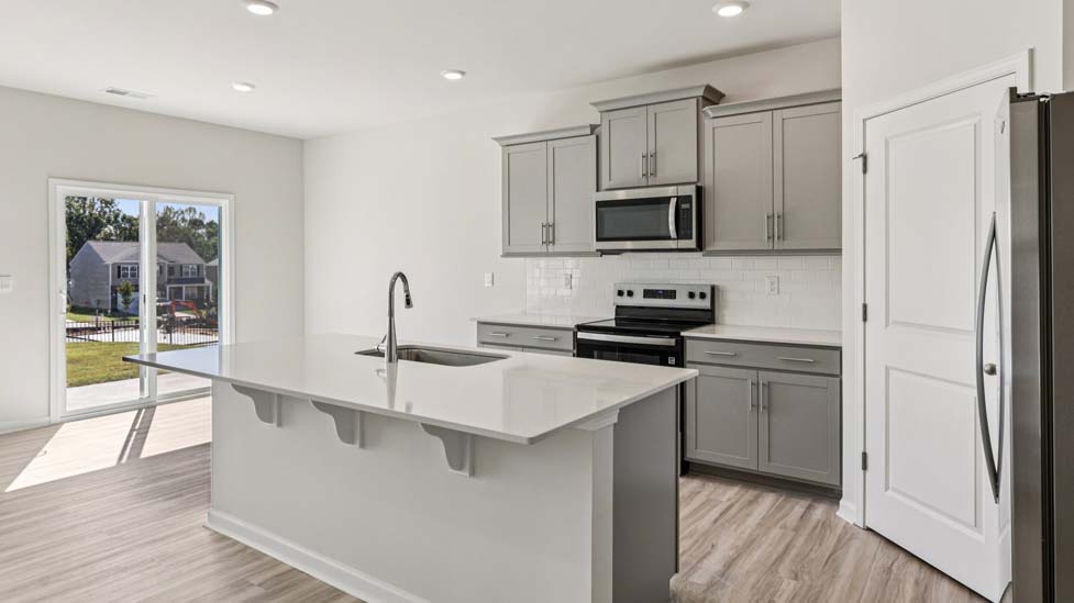 Kitchen and island with stainless steel appliances