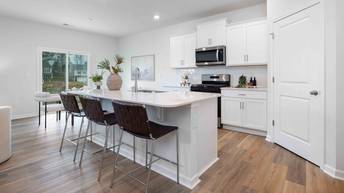 Kitchen and island with white cabinets