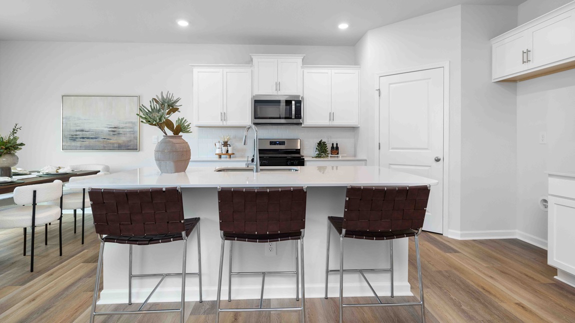 Kitchen and island with white cabinets