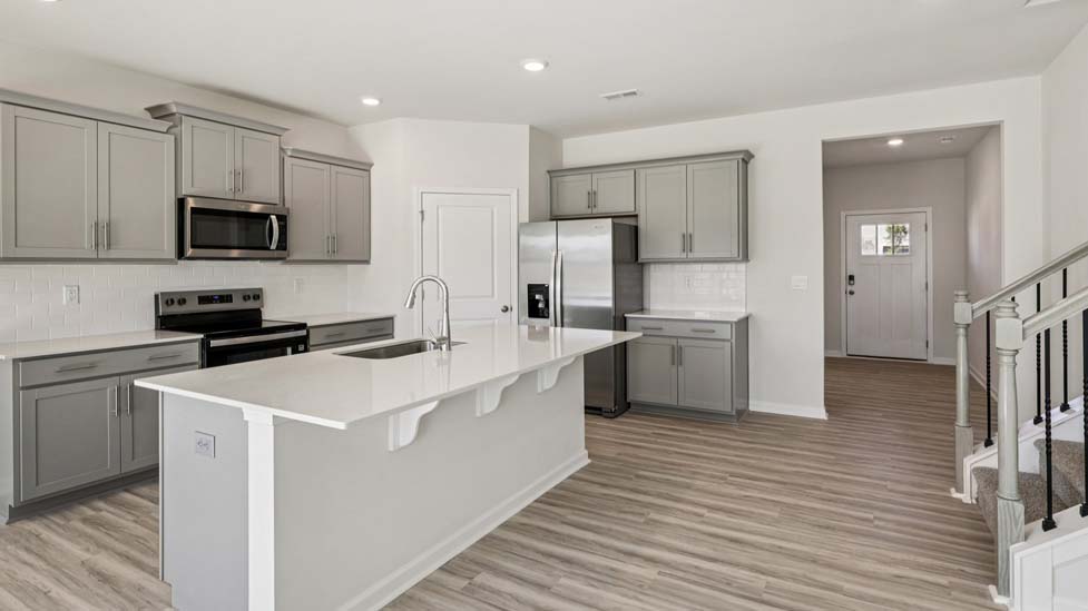 Kitchen and island with stainless steel appliances