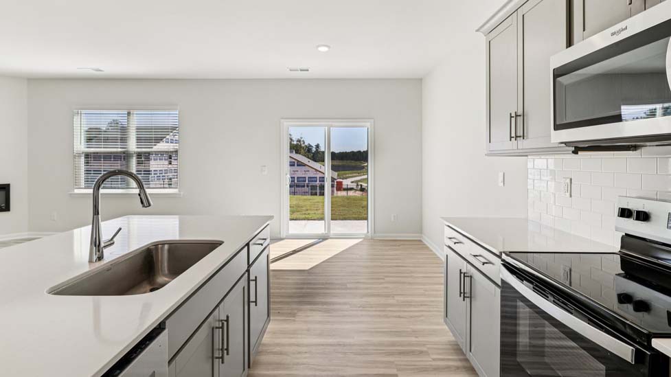 Kitchen and island with stainless steel appliances