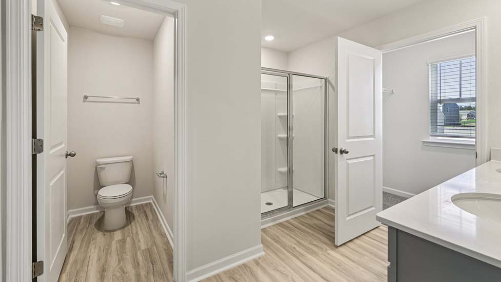 Primary bathroom with standing glass shower and double sinks