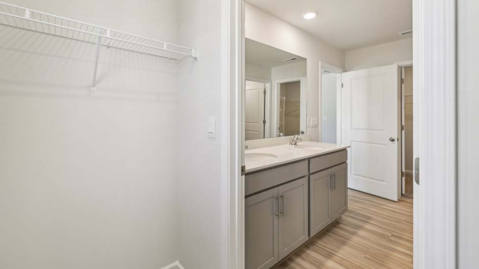 Primary bathroom with standing glass shower and double sinks
