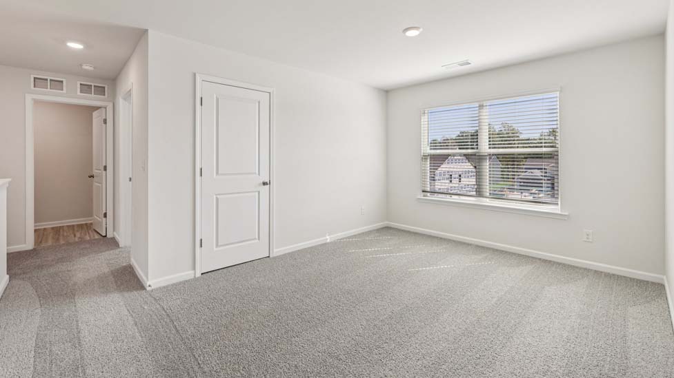 Carpeted bedroom with windows
