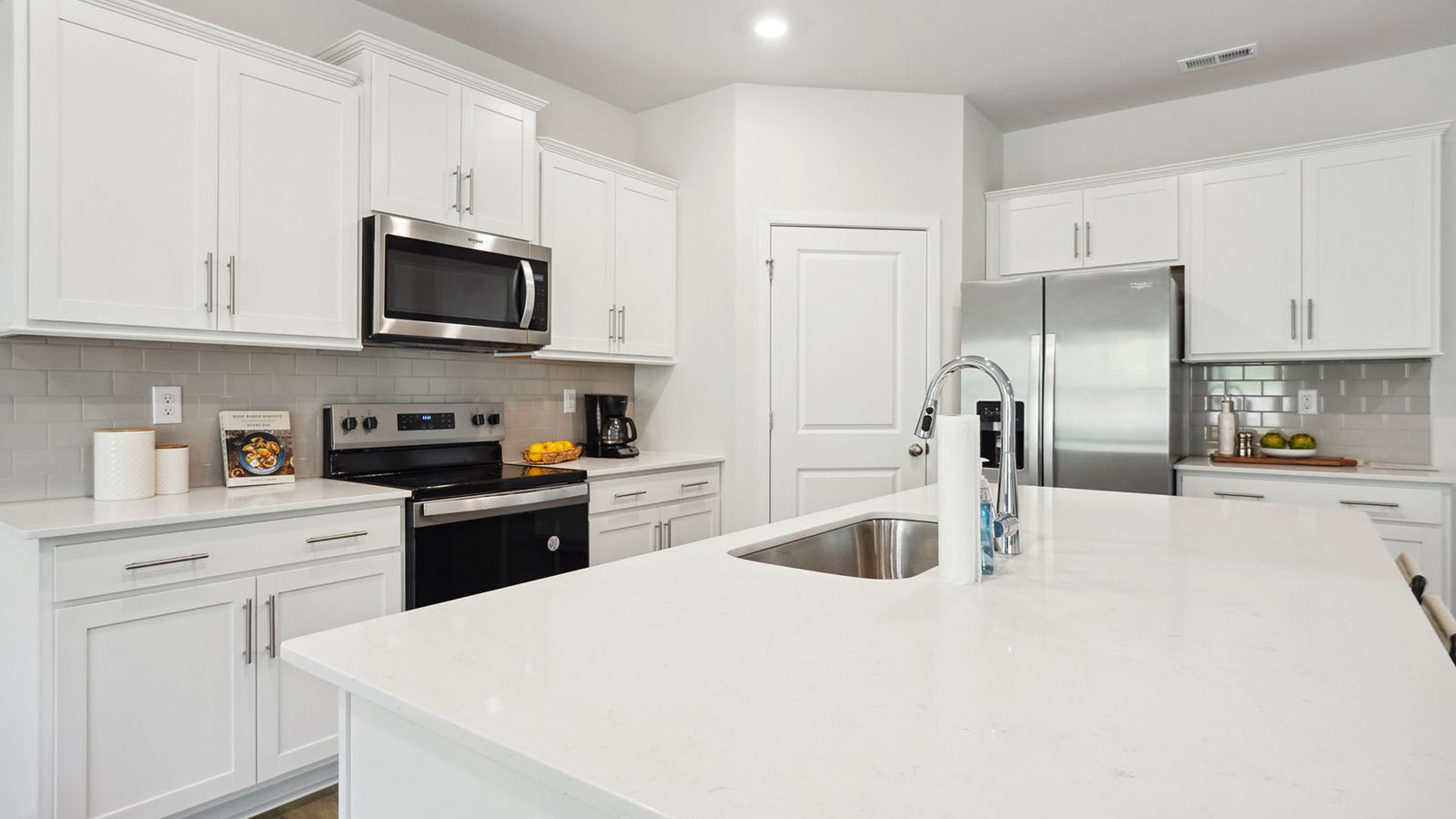 Kitchen and island with stainless steel appliances