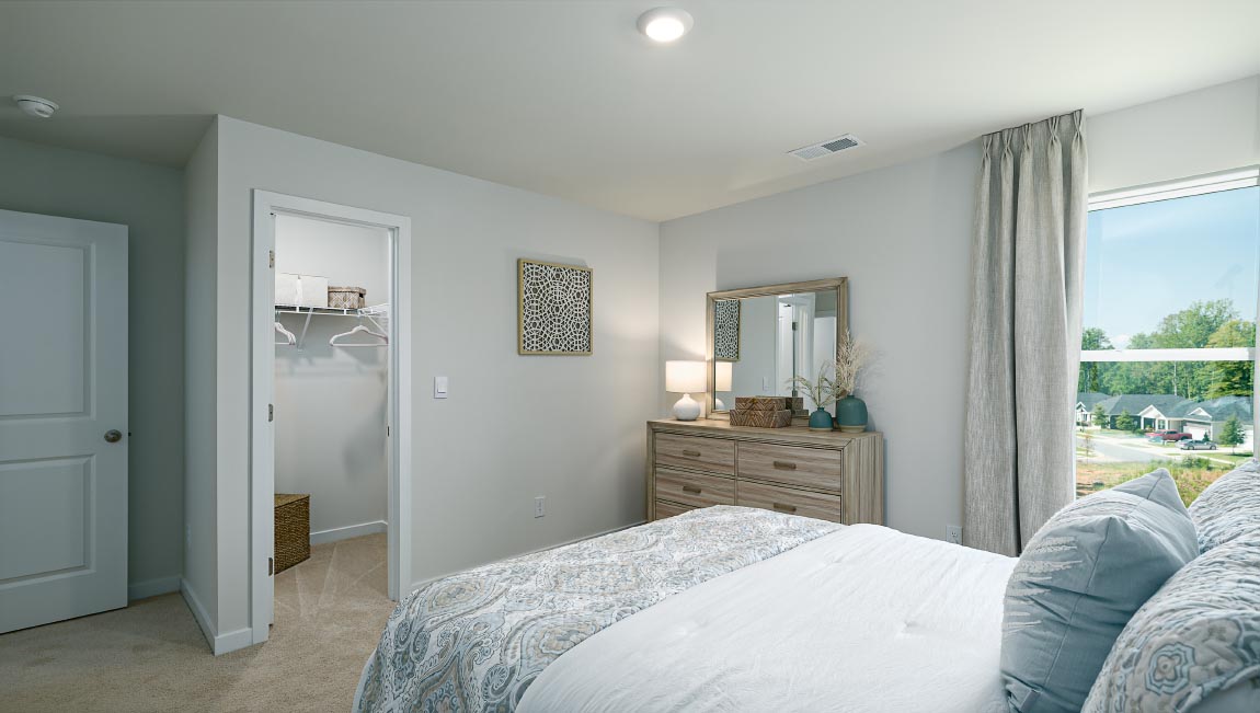 carpeted bedroom with two windows