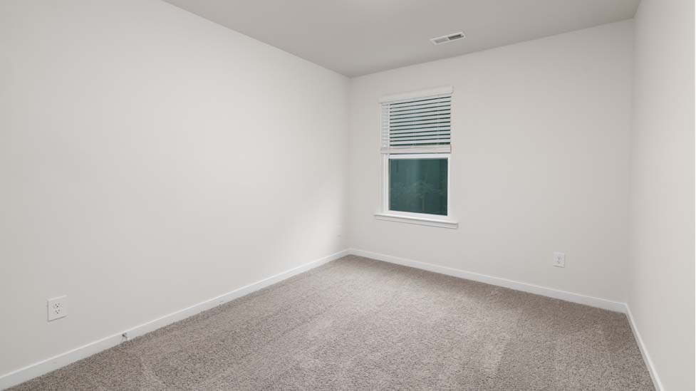 Carpeted bedroom with large window