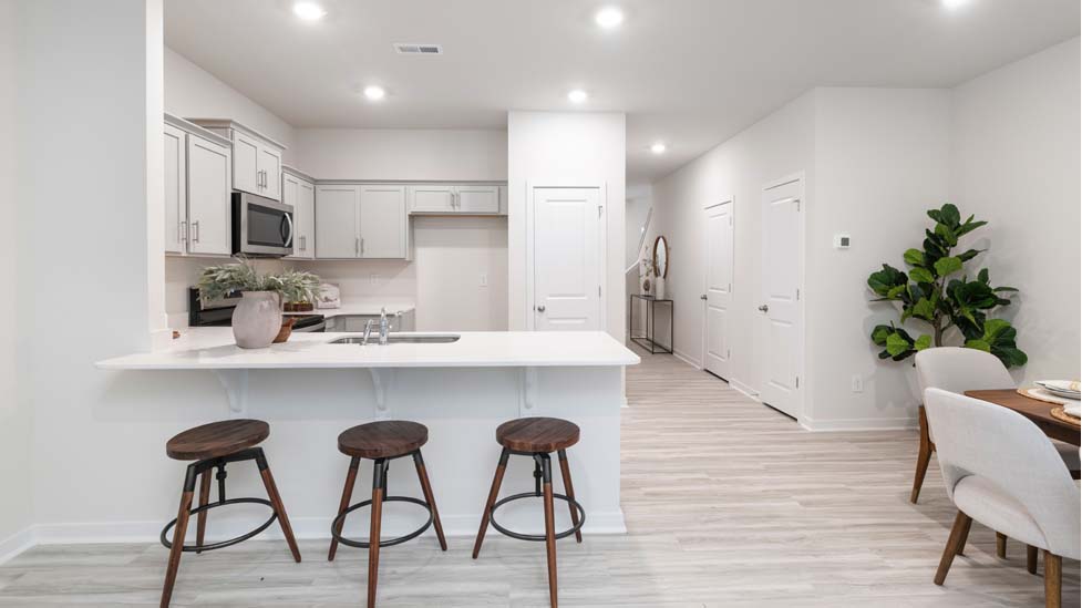 Kitchen and Island with white cabinets and stainless steel appliances