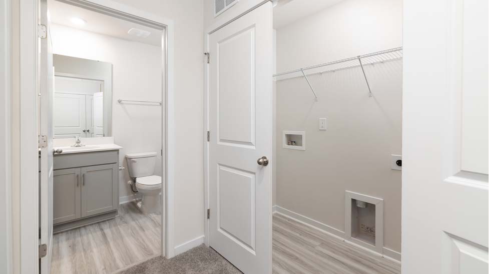 bathroom with white cabinets and standing glass shower