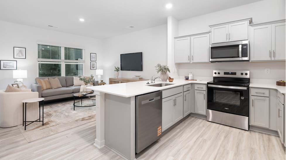 Kitchen and Island with white cabinets and stainless steel appliances
