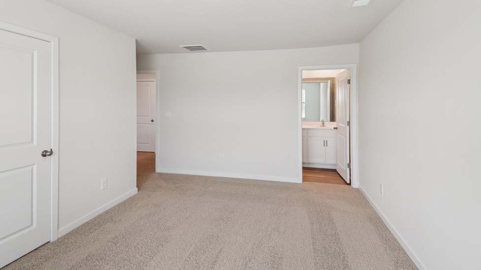 Carpeted bedroom with large window