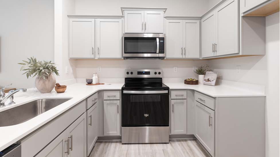 Kitchen and Island with white cabinets and stainless steel appliances