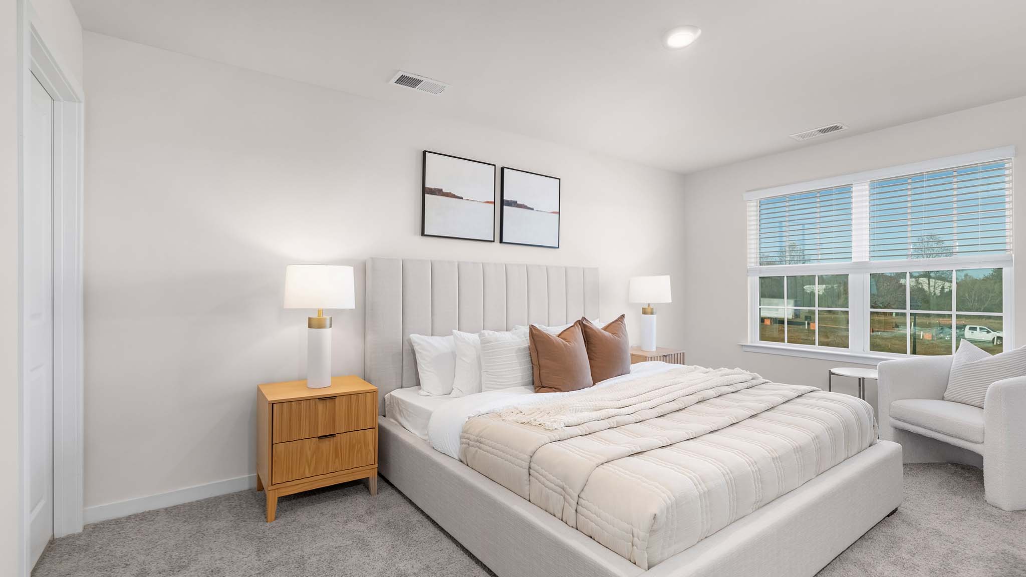 primary bedroom with carpet and large window