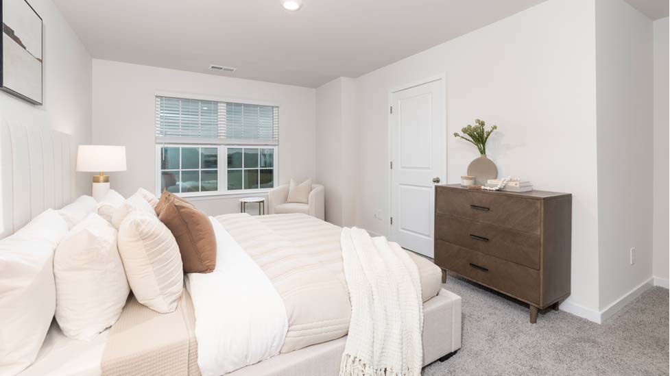 Carpeted bedroom with large window