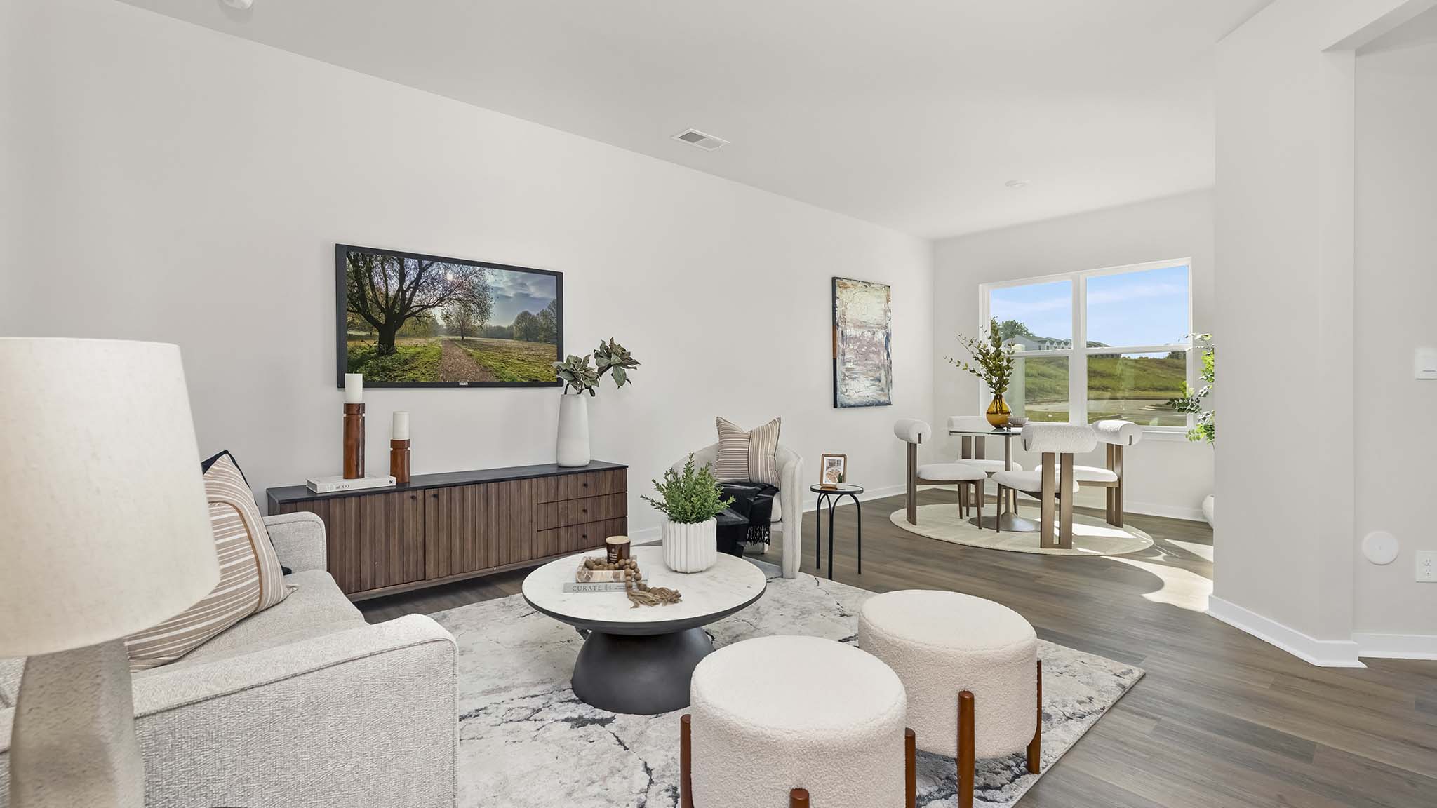 modern open family room with wood floor and large window