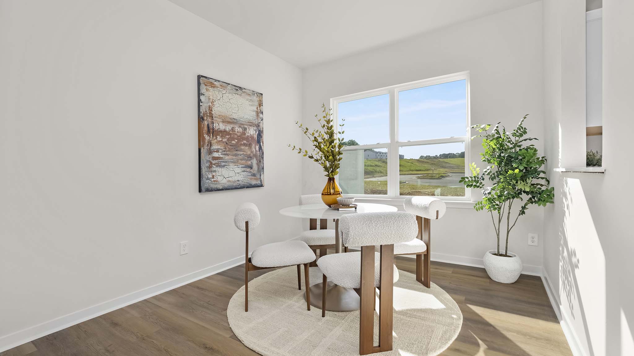 dining room with wood floors and large window