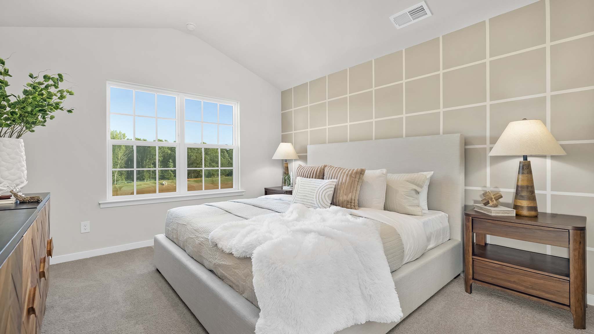 primary bedroom with carpet, and large window