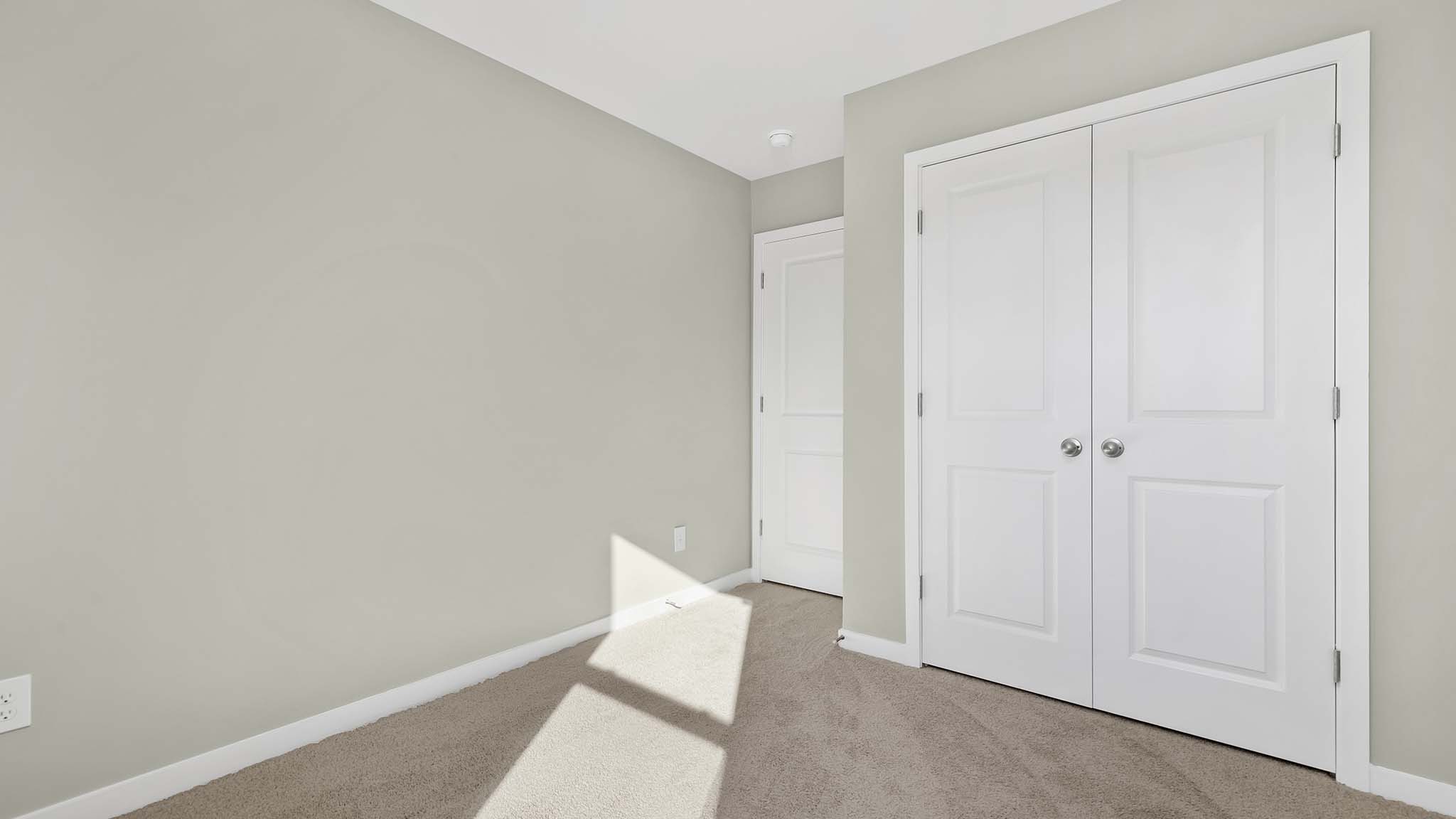 carpeted bedroom with small window