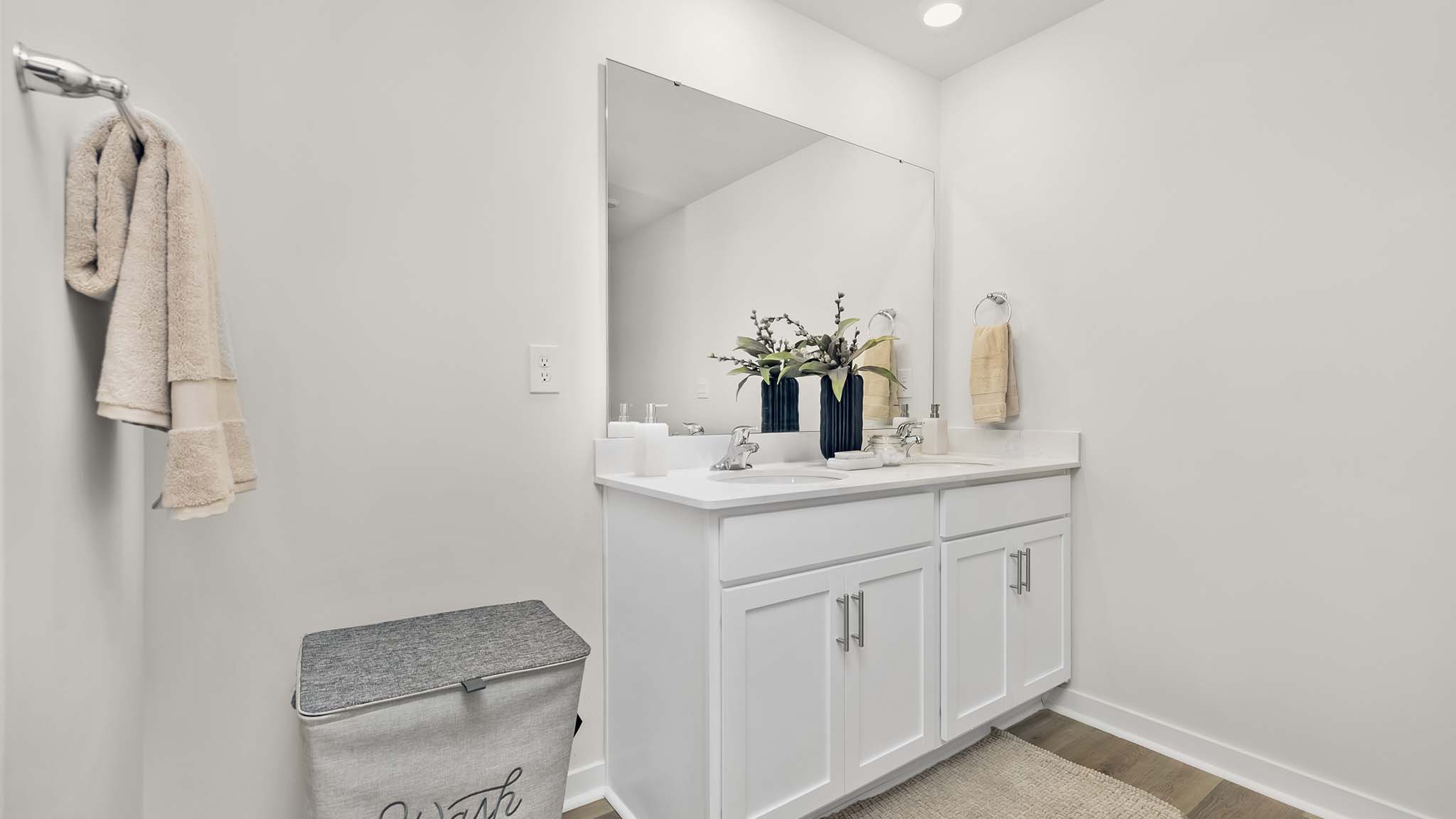 primary bathroom with double sinks, grey cabinets, and white counter