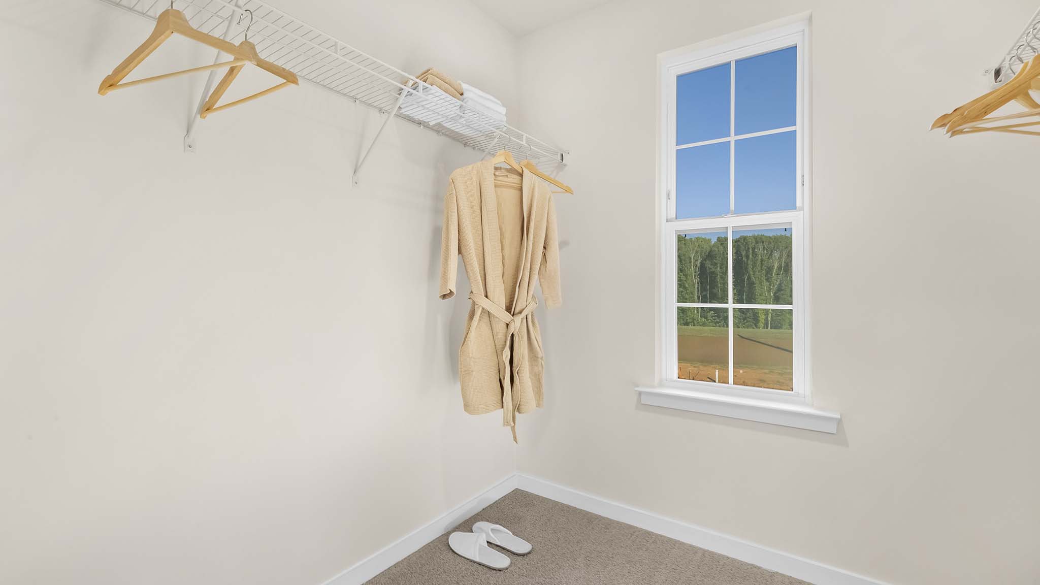 carpeted bedroom with small window