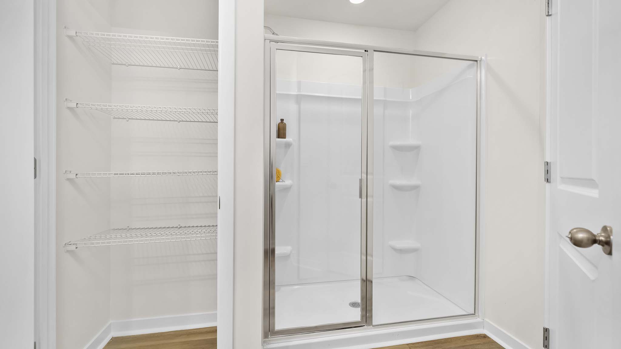 primary bathroom with double sinks, grey cabinets, and white counter