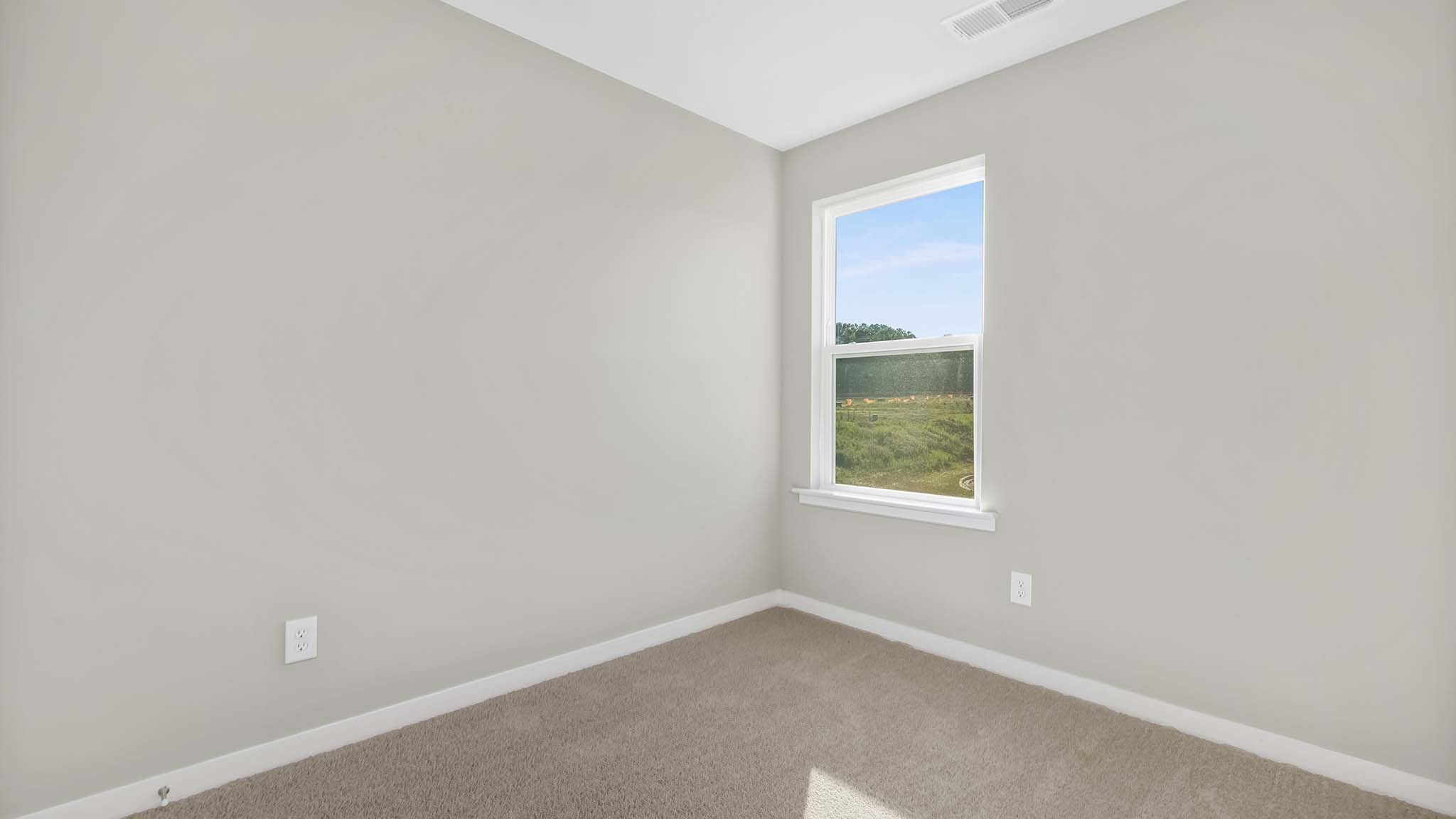 carpeted bedroom with small window