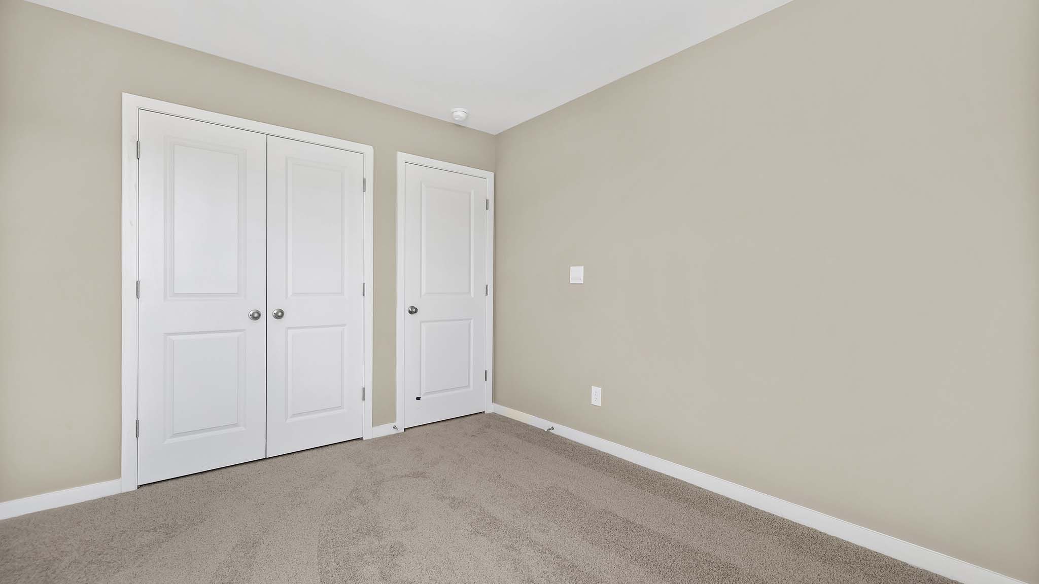 carpeted bedroom with small window