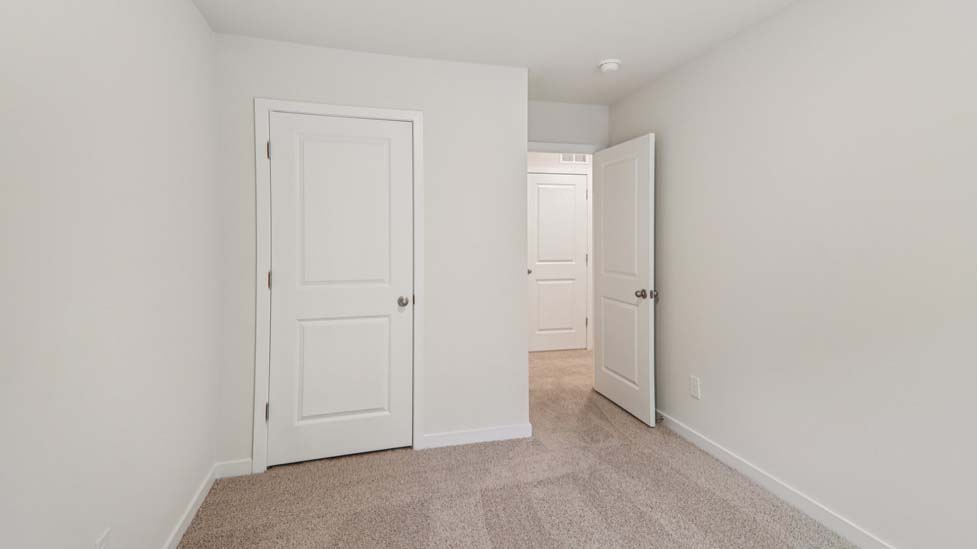 Carpeted bedroom with a large window