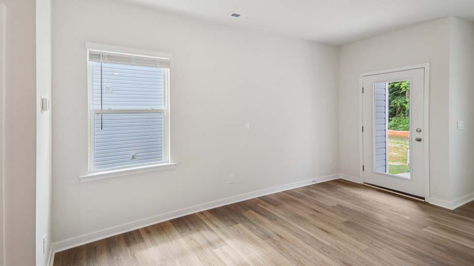 Dining area beside kitchen with large window and back door
