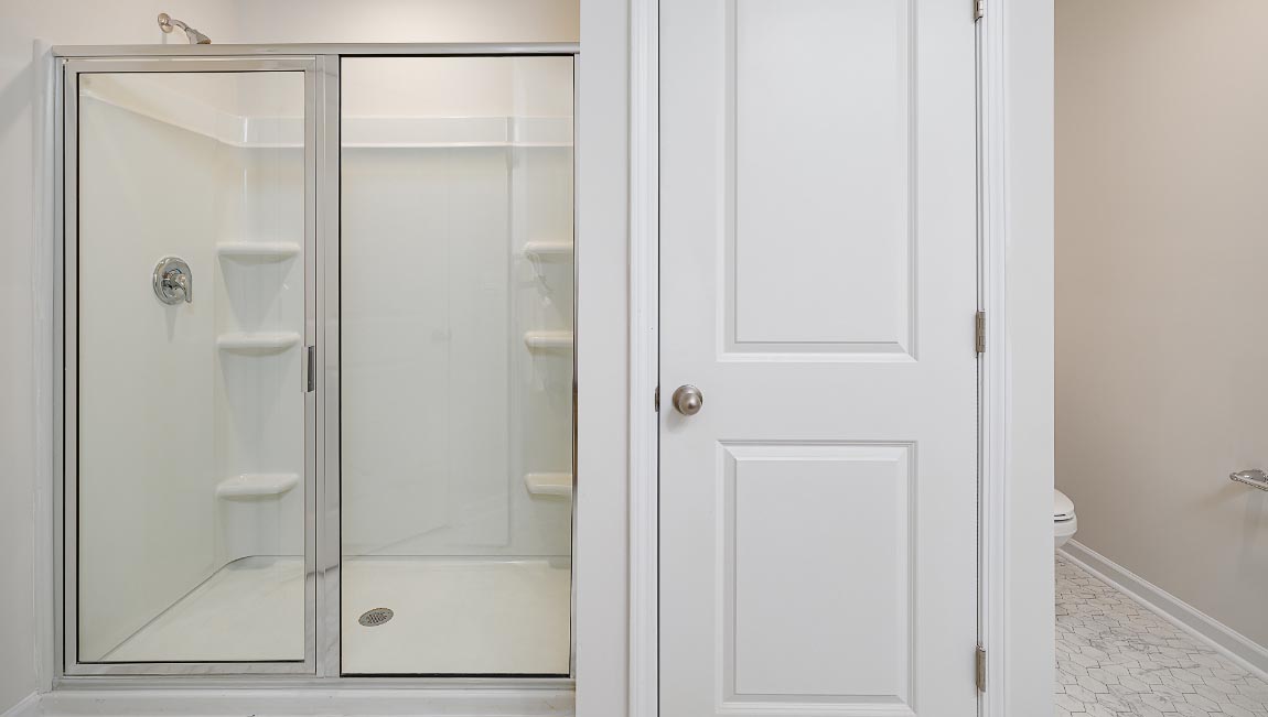 primary bathroom with double sinks, grey cabinets, and white counter
