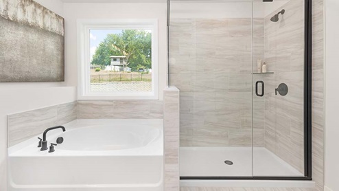 Primary bathroom with large soaking tub and standing shower