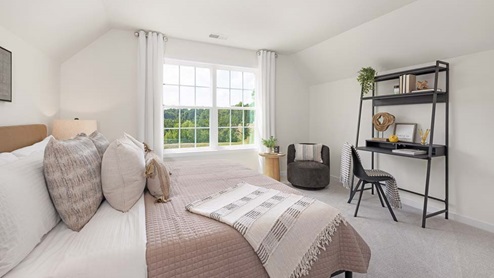 Carpeted bedroom with large windows